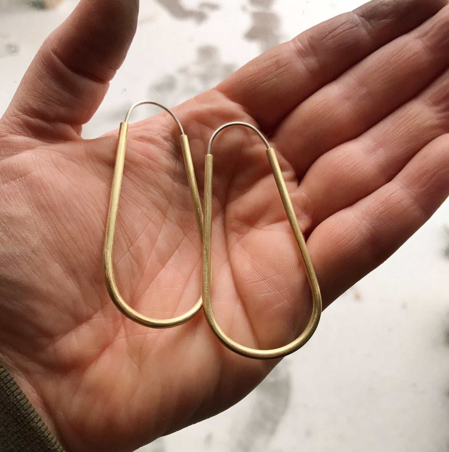 Long Hollow Brass Hoops by Modern Madini