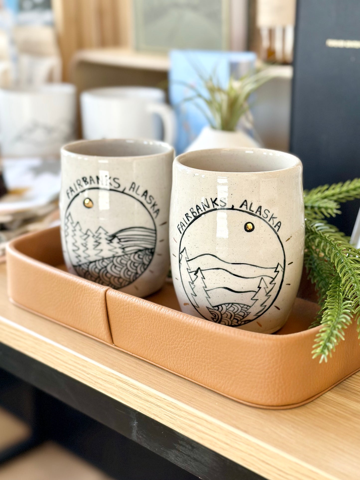 Ceramic mugs with 'Fairbanks, Alaska' drawn on a ceramic surface