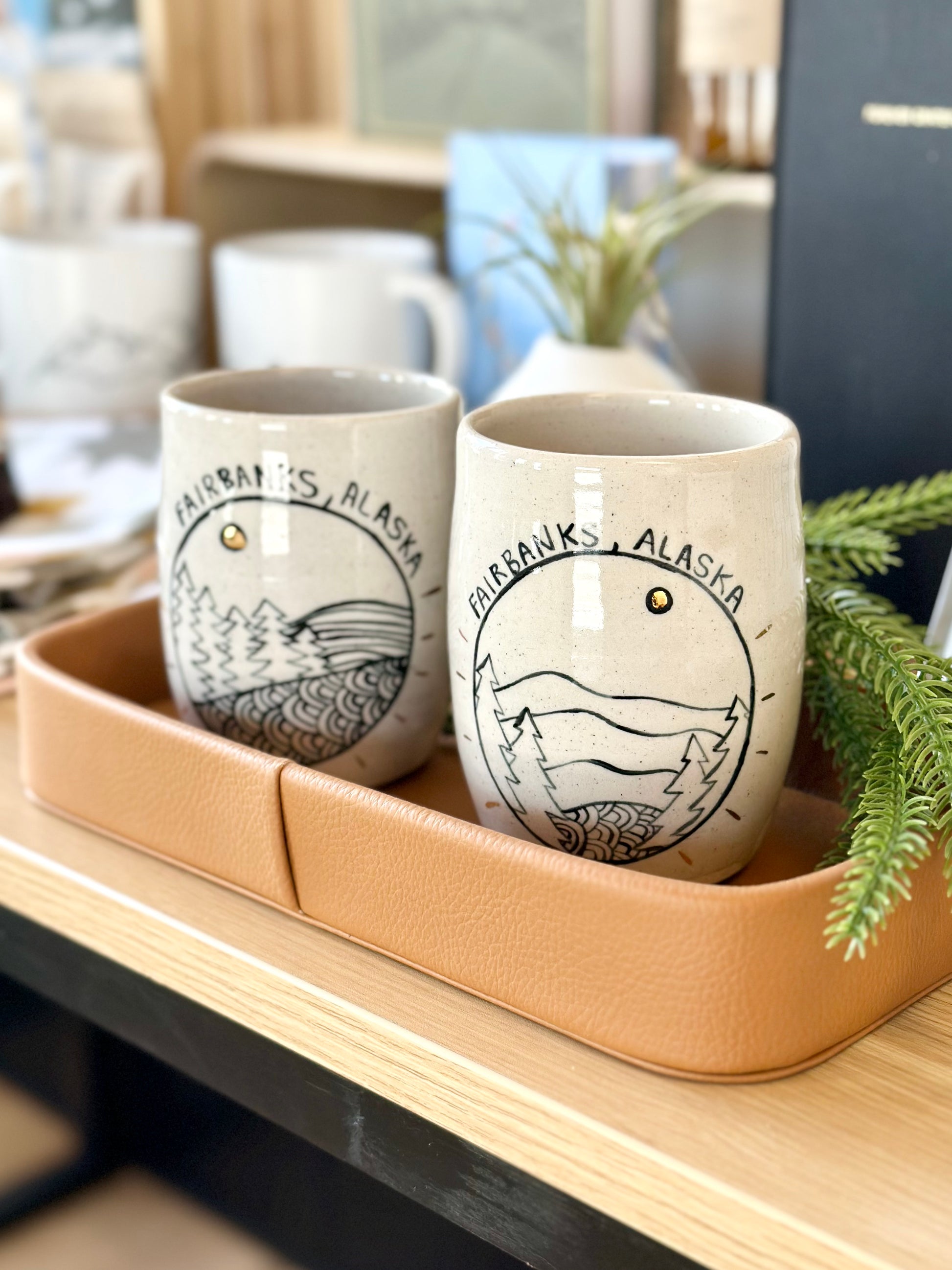 Ceramic mugs with 'Fairbanks, Alaska' drawn on a ceramic surface