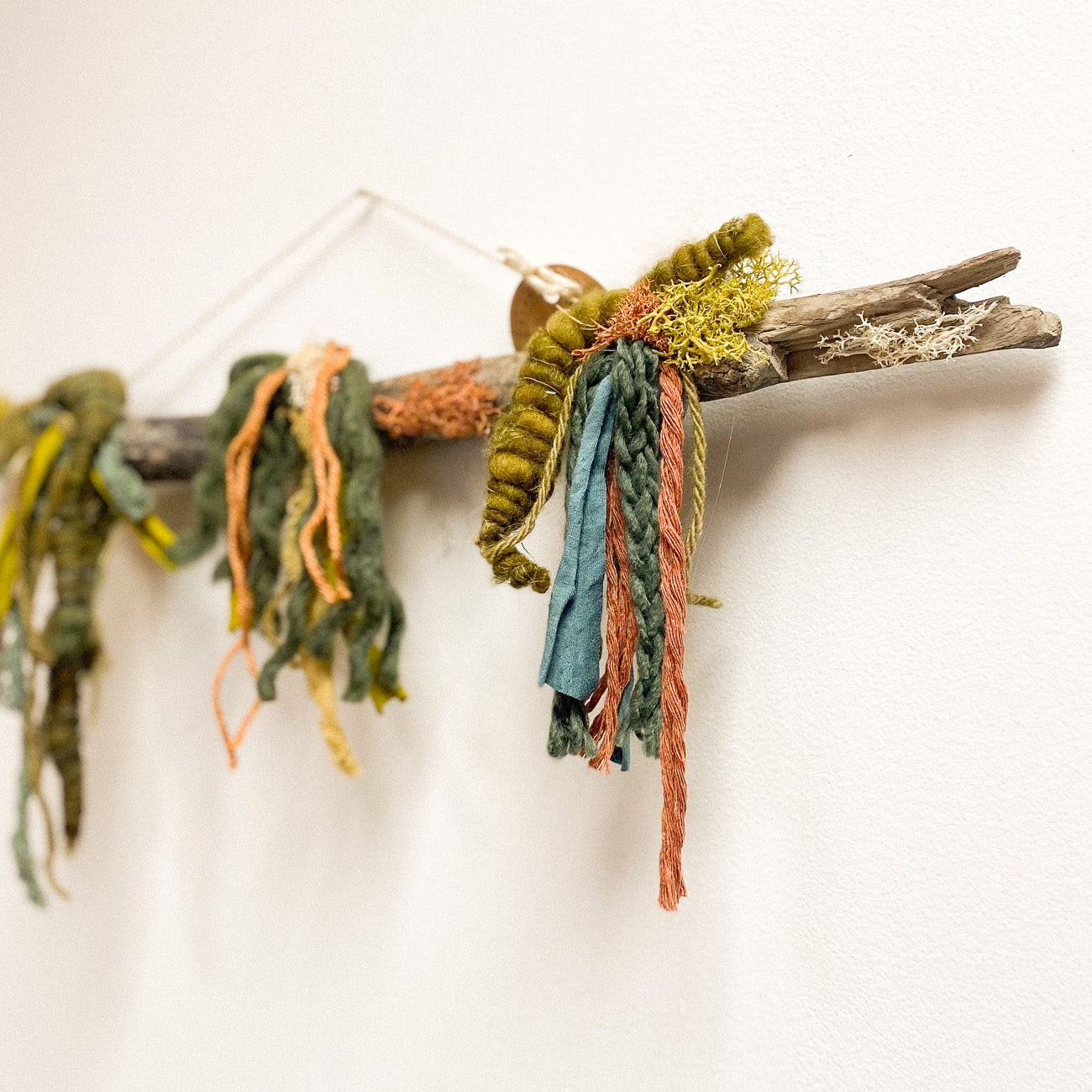 Decorative garland made of ribbons and twigs on a white background