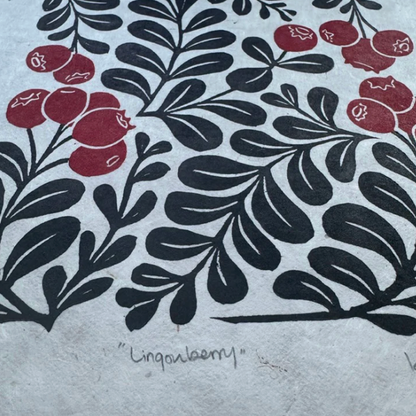 Artistic print of black leaves and red berries on textured paper with 'Lingonberry' text.