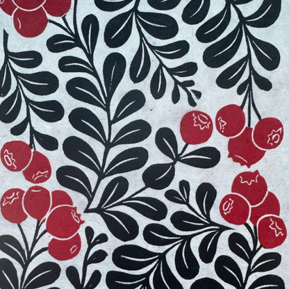 Pattern of black leaves and red berries on a light gray background