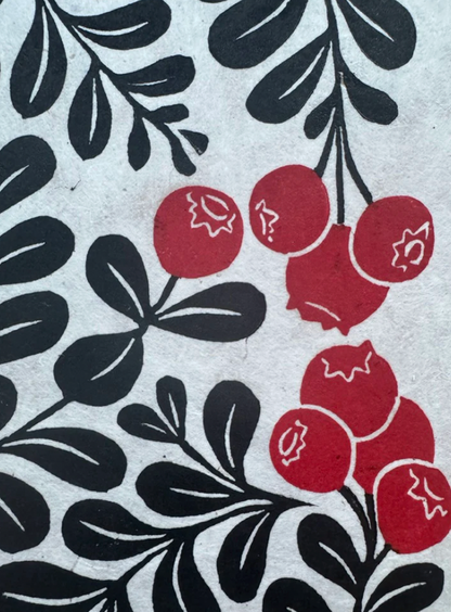 Pattern of red berries and black leaves on a textured background