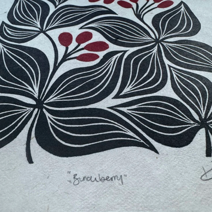 Black floral design with red berries on a white background