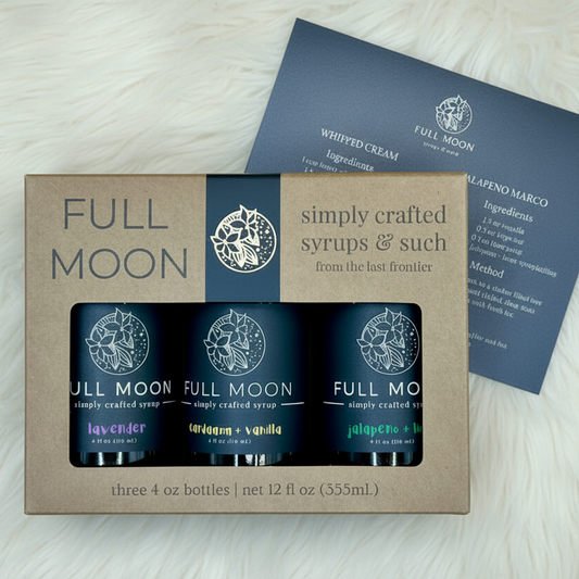Full Moon syrup set with three bottles in a cardboard box on a beige background